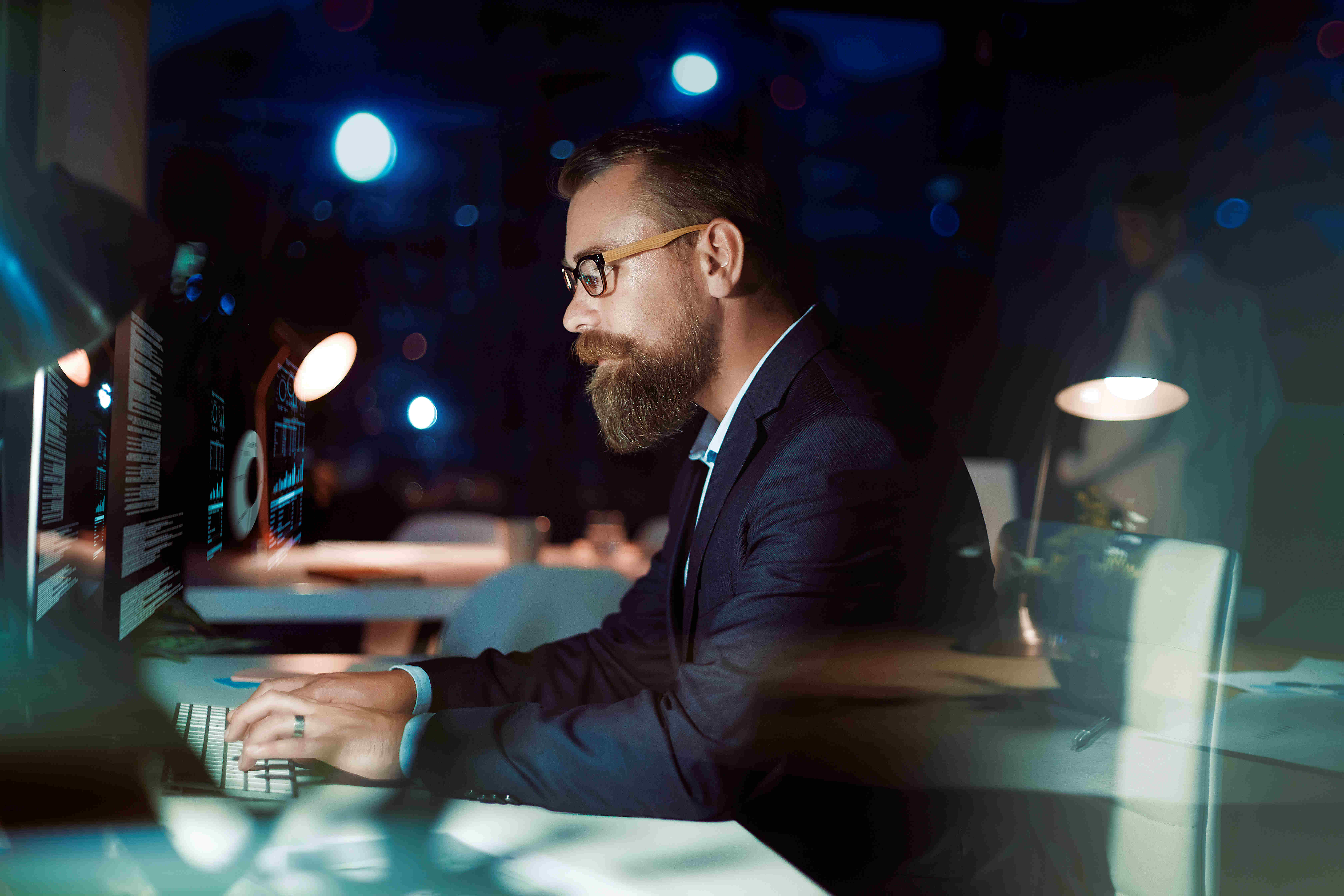 Bearded man sitting in front of computer