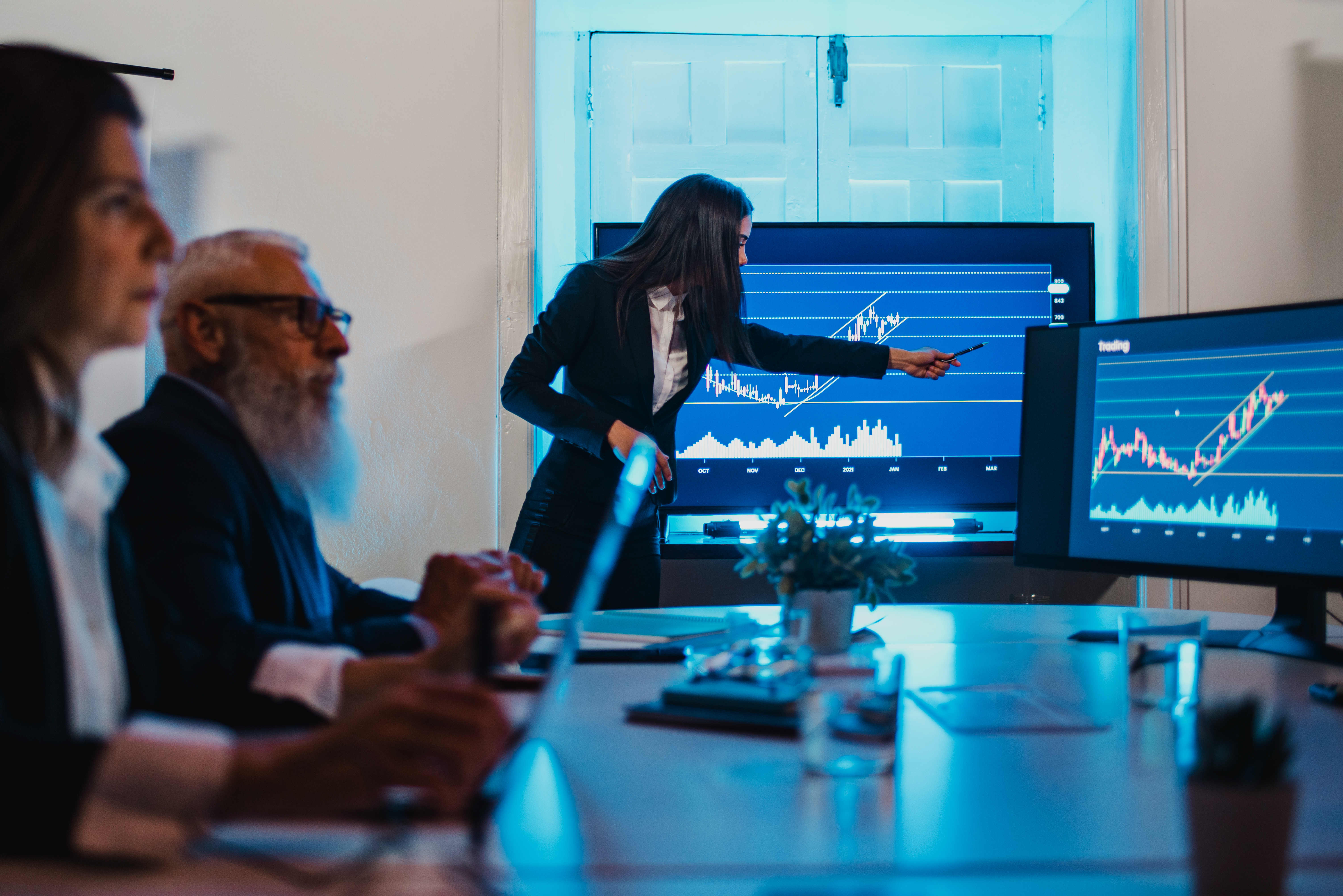 Woman presenting data graph to meeting