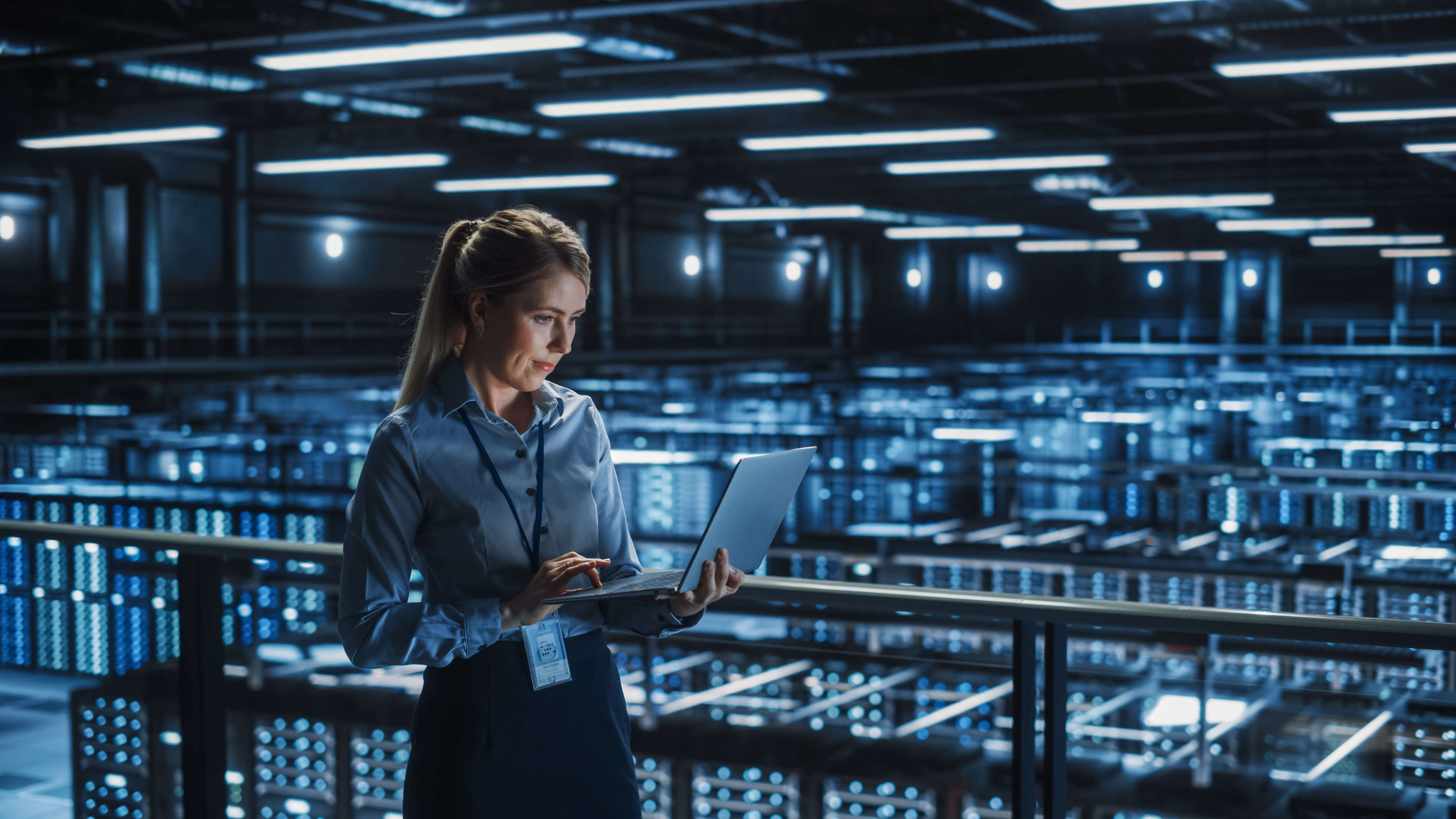 woman working on tablet standing in server room